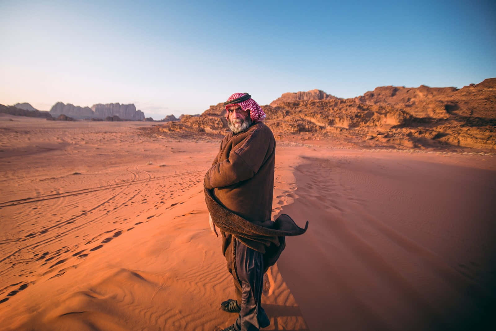 Arab Man Standing In Desert Wallpaper