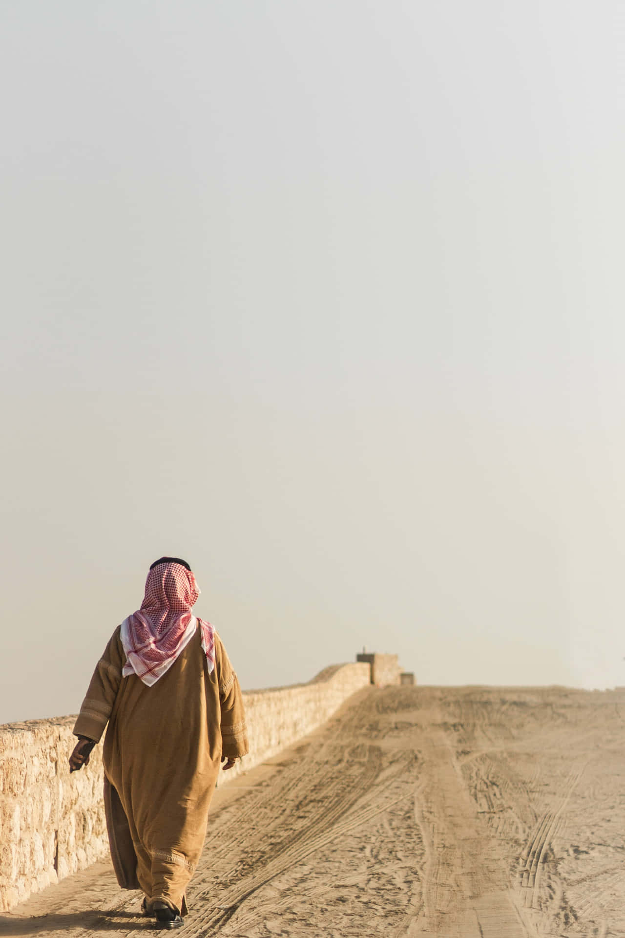 Arab Man Walking At The Side Of Road Wallpaper