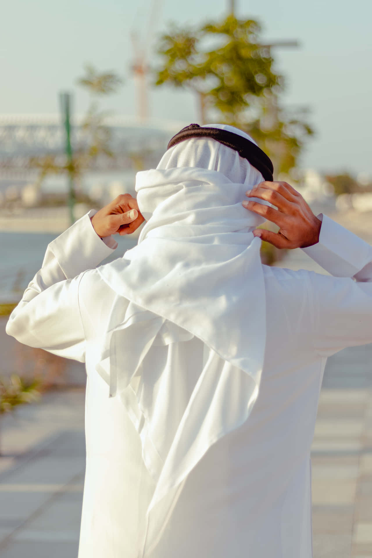 Arab Man Wearing White Thobe Back View Wallpaper