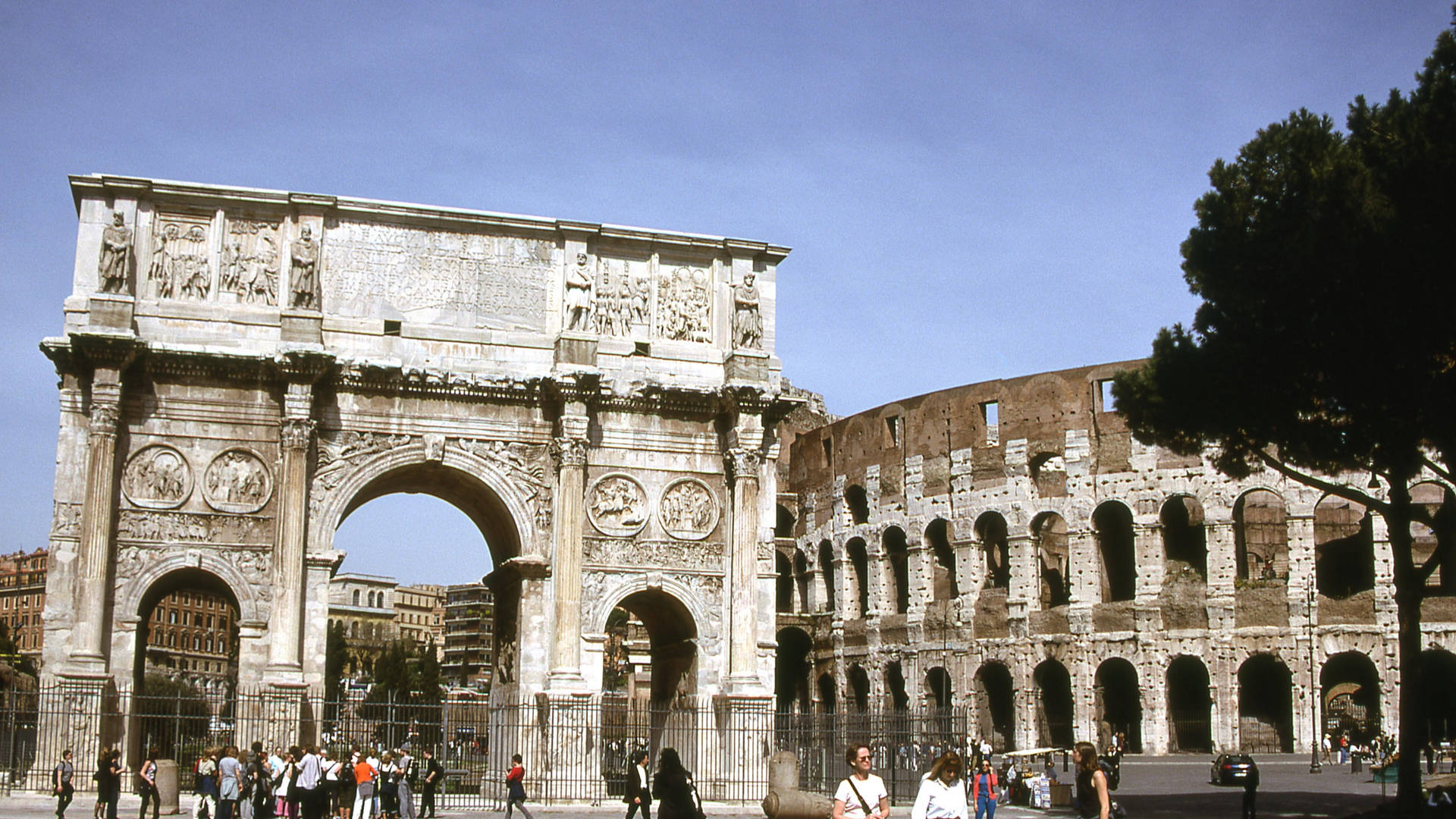 Majestic View of the Arch of Constantine with the Colosseum in the Background Wallpaper