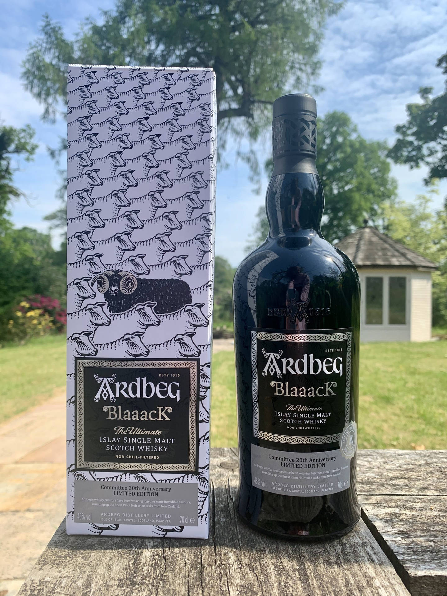 Ardbeg Blaaack Whisky Bottle And Box In Garden Wallpaper