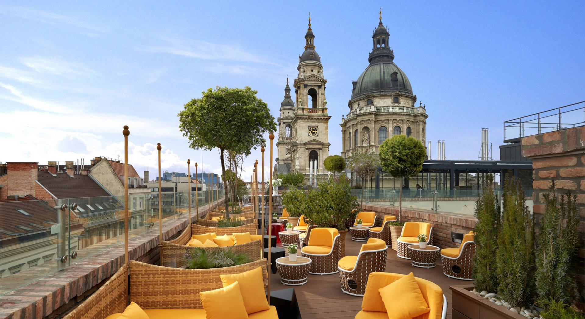 a rooftop with yellow chairs and a church Wallpaper