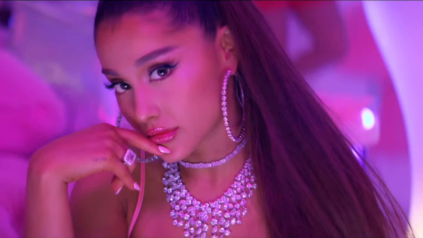 Ariana Grande dancing in front of a rainbow with her 7 Rings as she celebrates 2019 Wallpaper