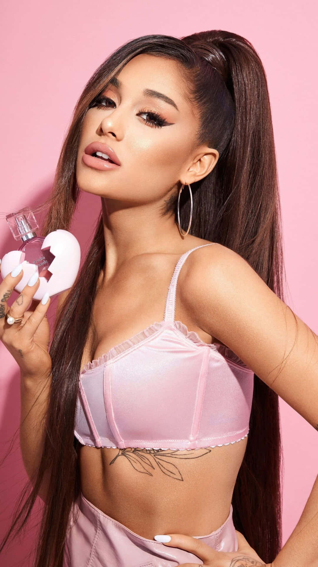 Ariana Grande Pink Backdrop Promoting Fragrance Wallpaper