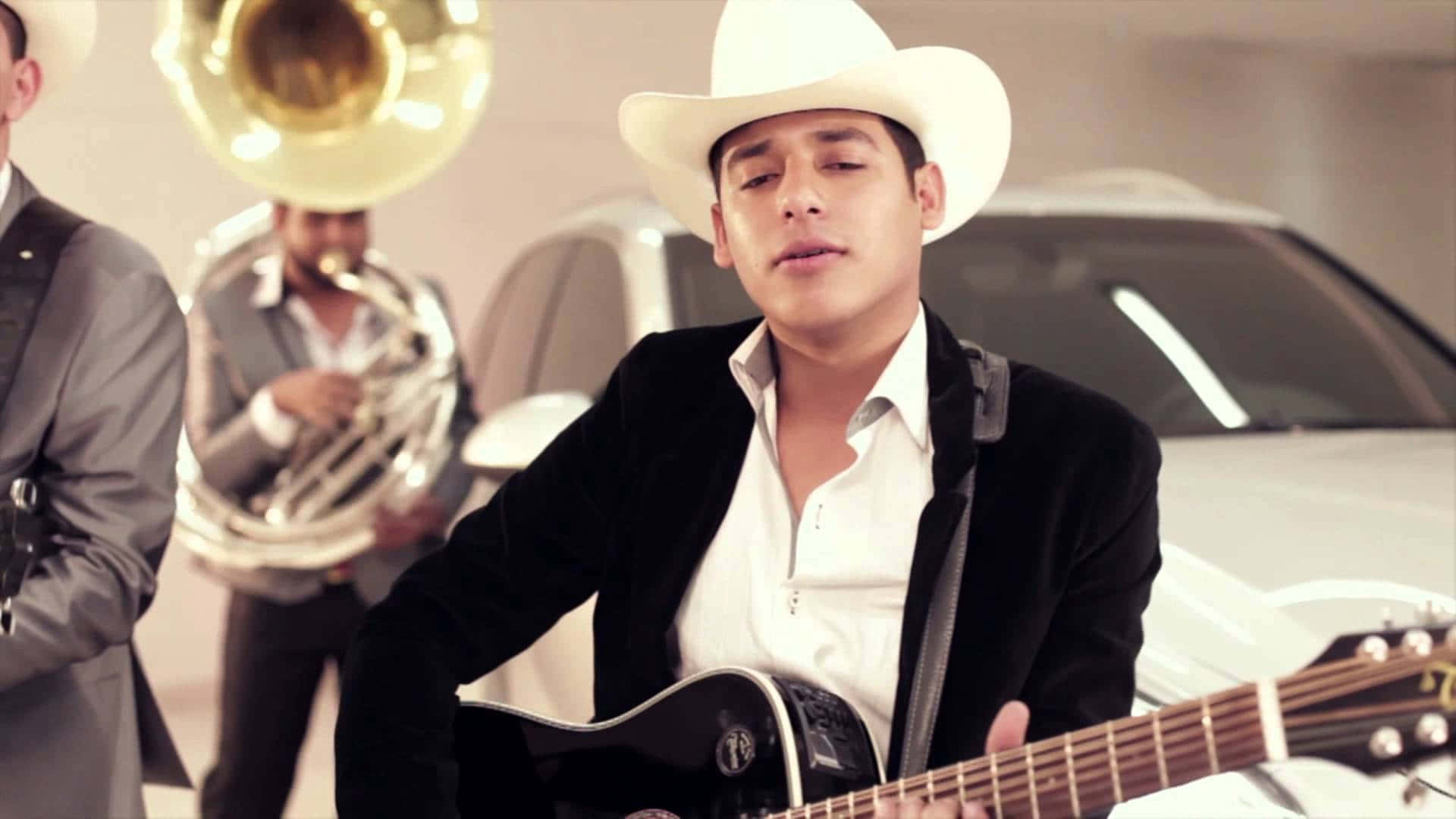 Unhombre Con Sombrero De Vaquero Toca Una Guitarra Acústica. Fondo de pantalla