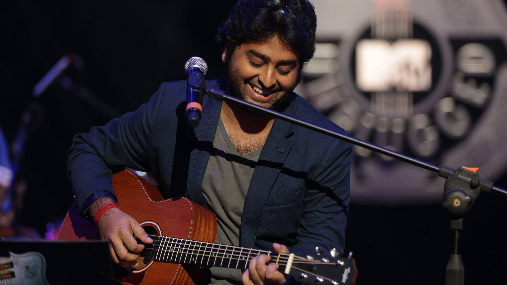 Arijit Singh Playing Guitar On Stage Background