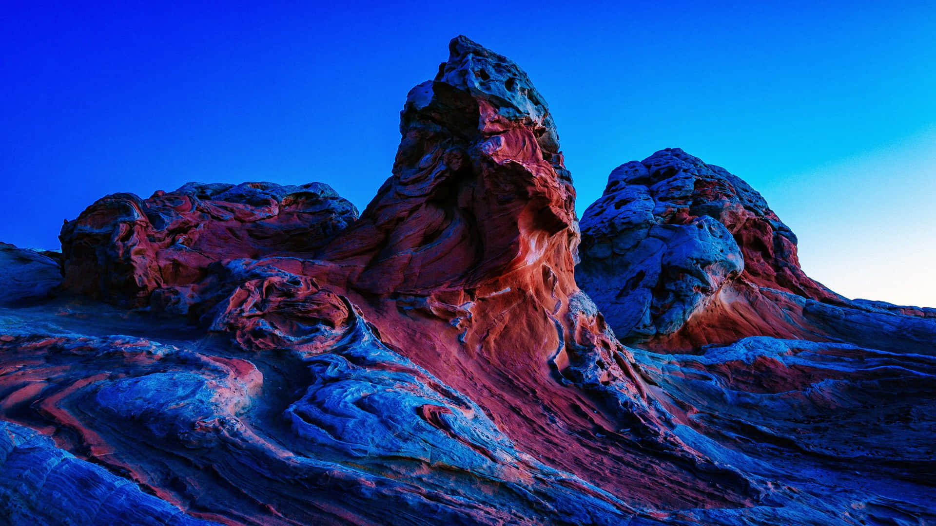A Red And Blue Rock Formation In The Desert