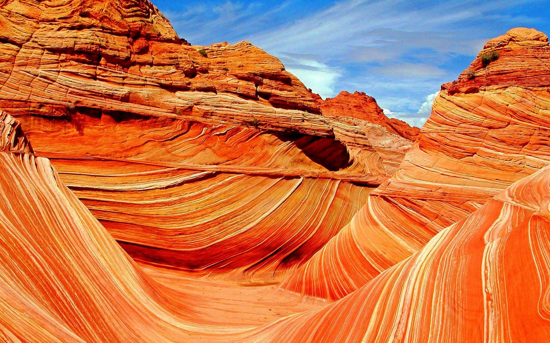 A Red Rock Formation With A Wave Pattern