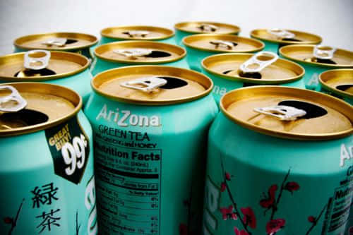 Arizona Tea Cans With Gold And Pink Flowers Wallpaper