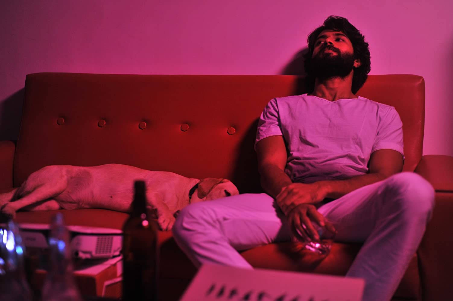 Striking portrait of Arjun Reddy from the acclaimed movie, illuminated in pink light Wallpaper