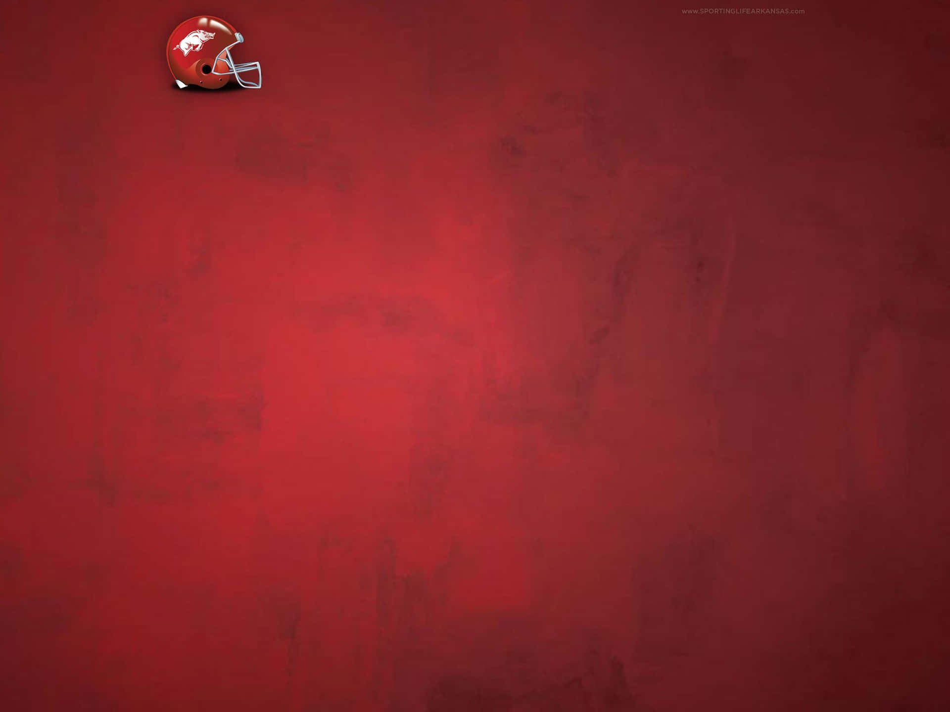 Unfondo Rojo Con Un Casco De Fútbol Americano En Él Fondo de pantalla
