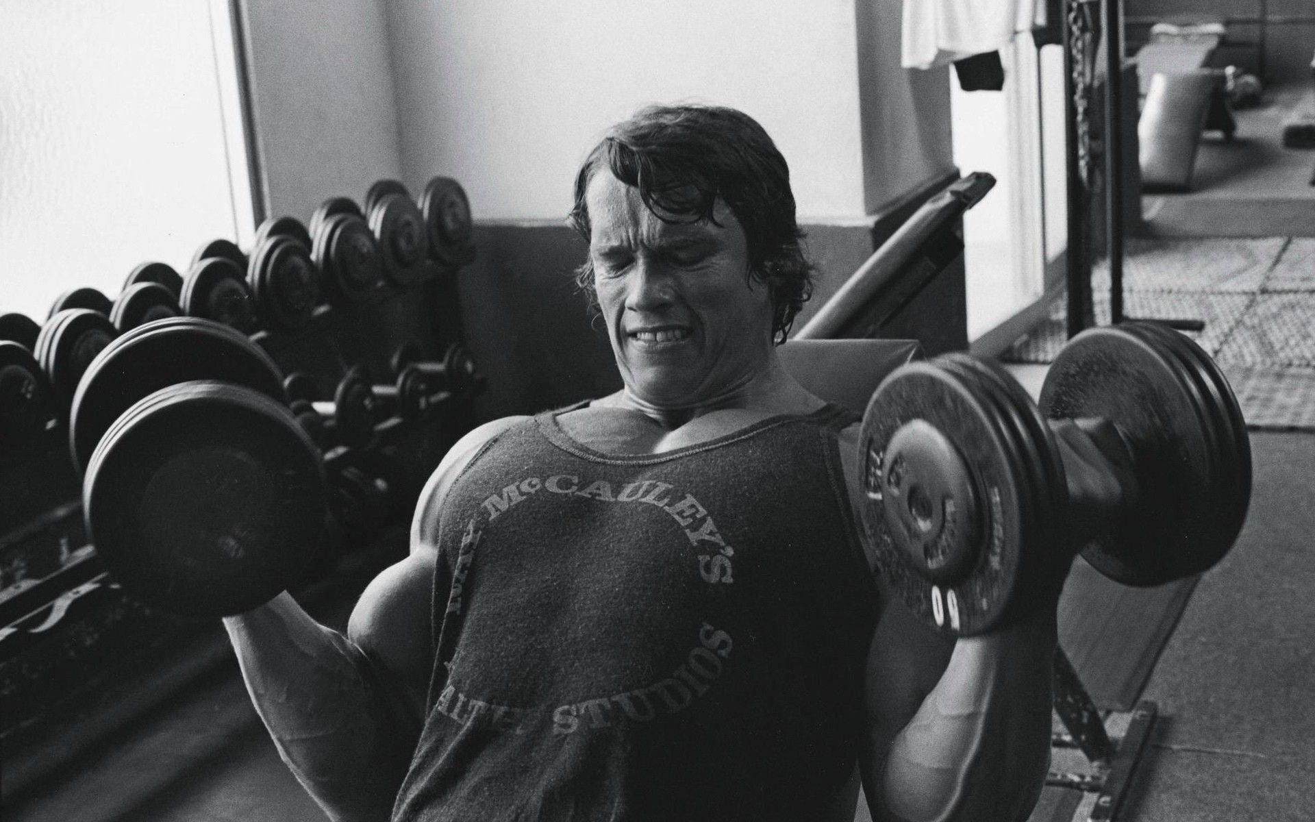 Arnold Schwarzenegger Lifting Weights Background