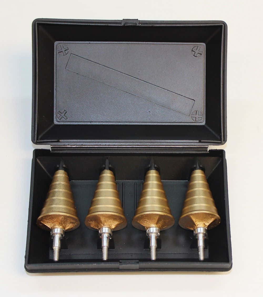 A Set Of Four Drill Bits In A Black Case