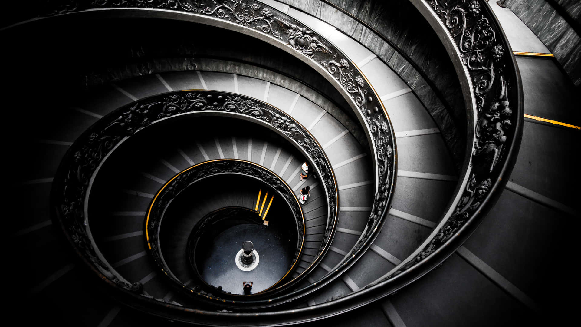 A Spiral Staircase With A Person On It Wallpaper