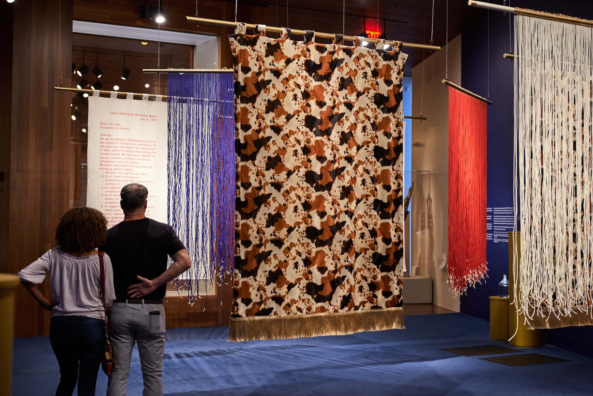 Art Exhibition Visitors Admiring Tapestries Wallpaper