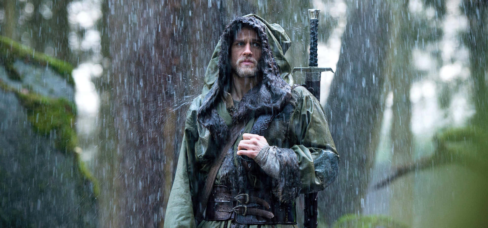 A Man In A Raincoat Holding A Sword