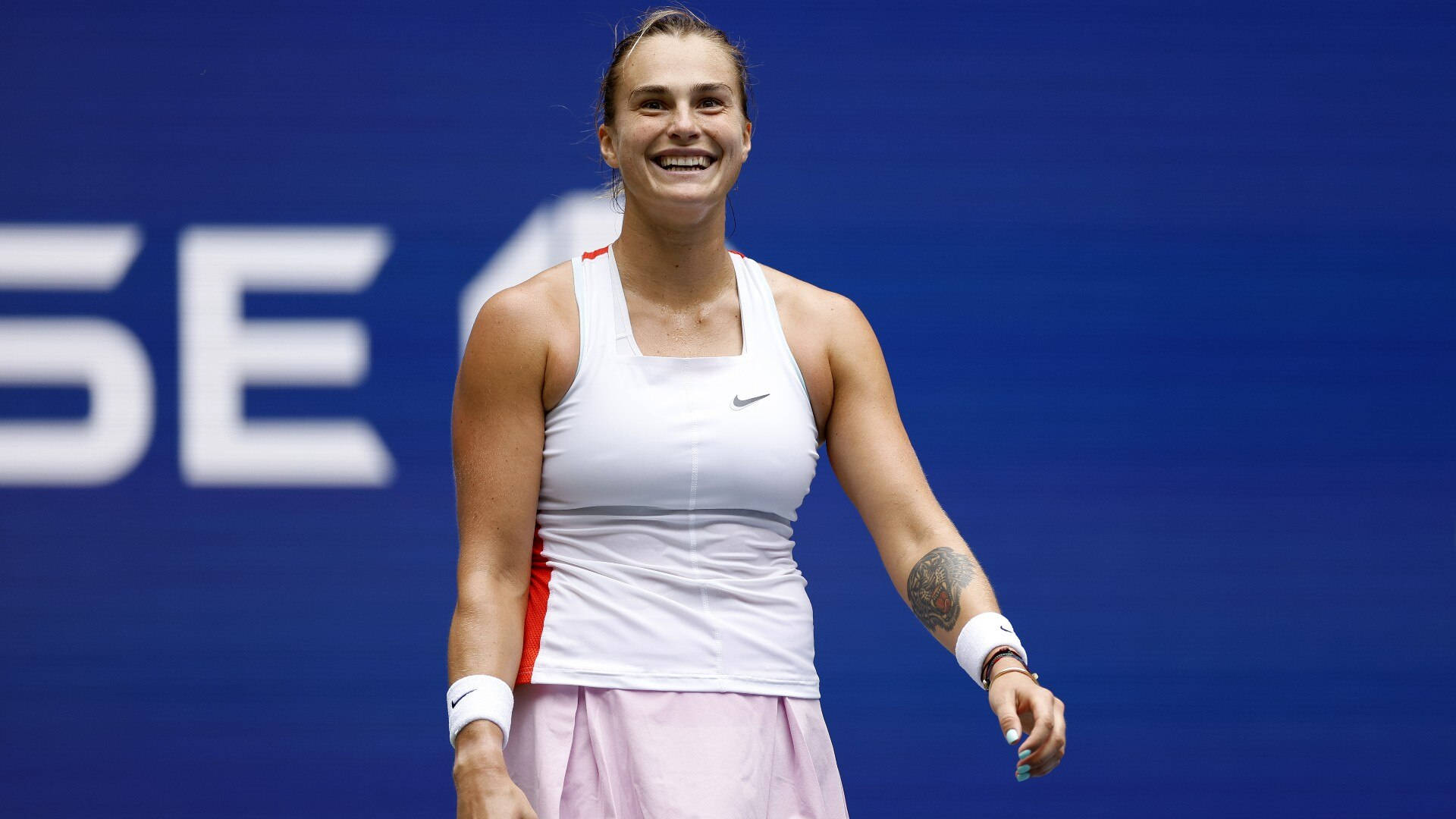 Aryna Sabalenka - Professional Tennis Player with Winning Smile Wallpaper