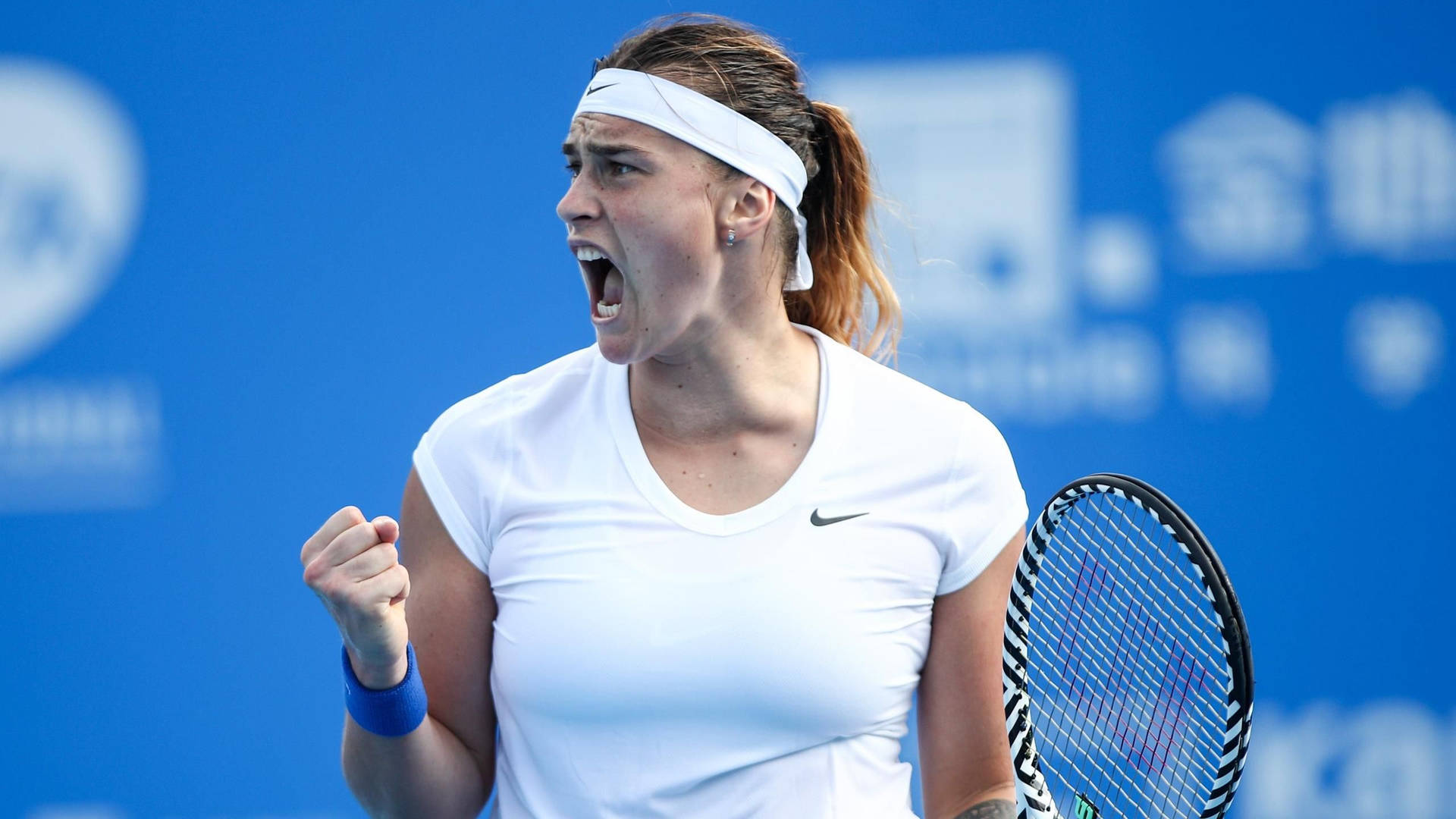 Aryna Sabalenka Expressing Intensity on the Tennis Court Wallpaper