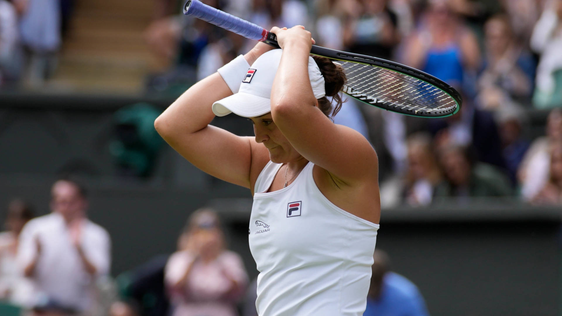 Ashleigh Barty Holding Racket Above Head Wallpaper