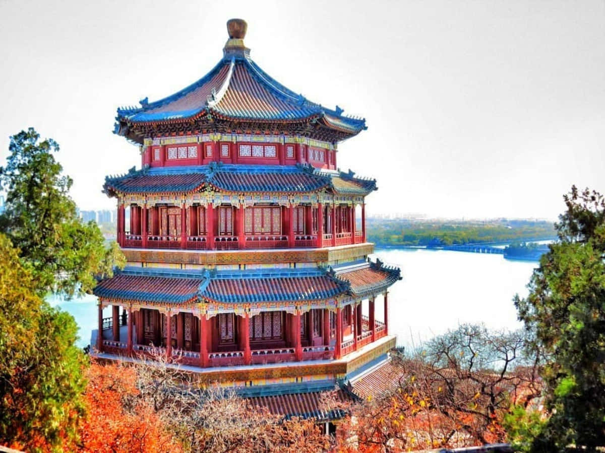A Red Pagoda Sits On Top Of A Hill