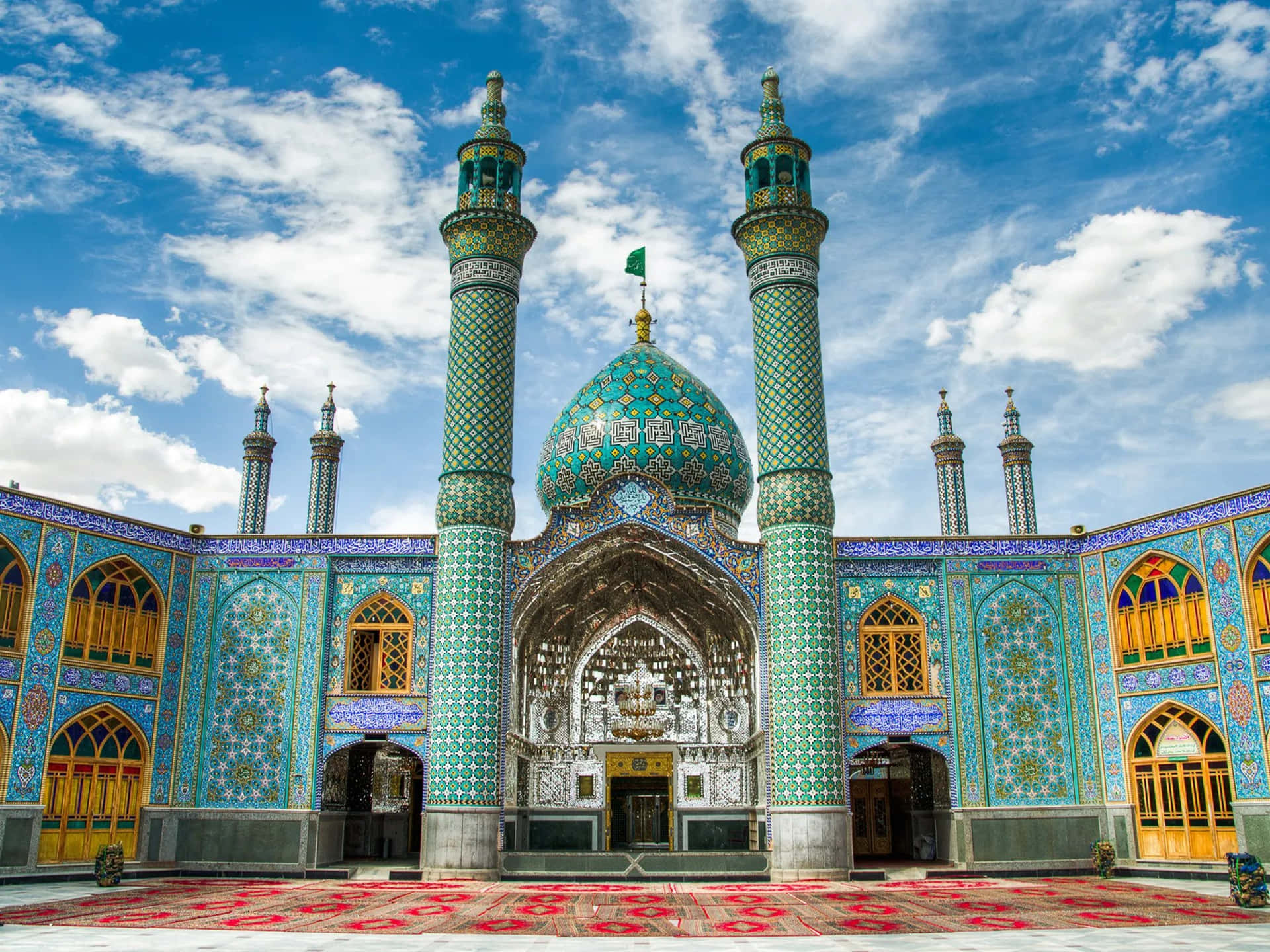 A Mosque With Blue And Green Tiled Roofs