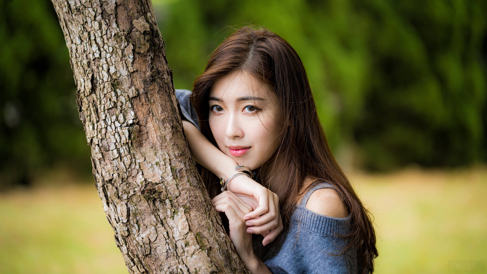 Asian Women Leaning On Tree Trunk Background