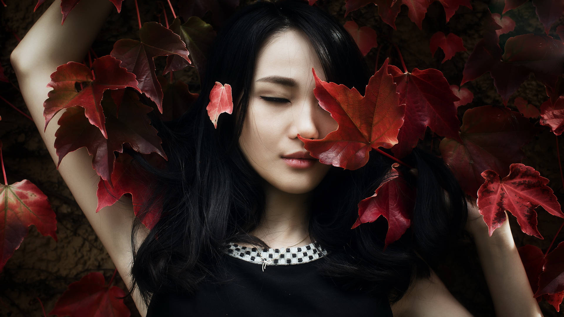 Asian Women Lying On Red Leaves Background