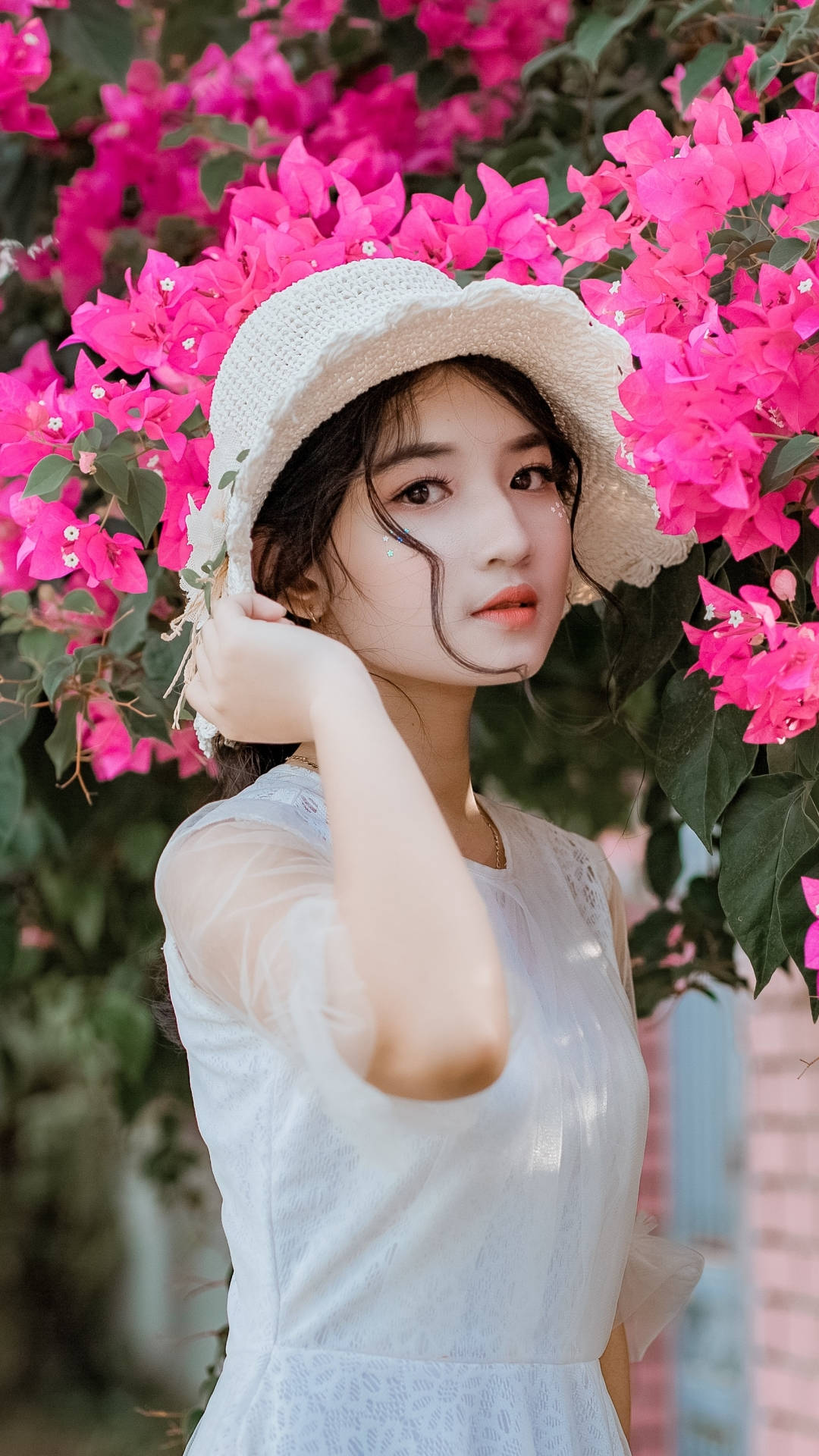 Asian Women Posing By The Flowers Background
