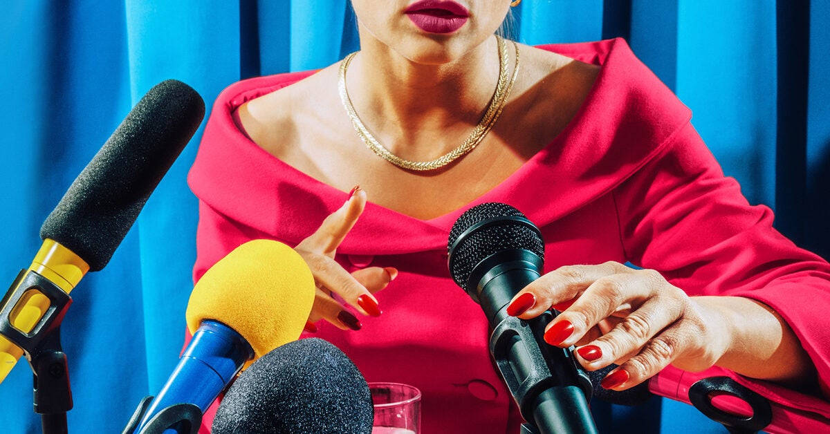 A Woman Is Talking To Microphones Wallpaper