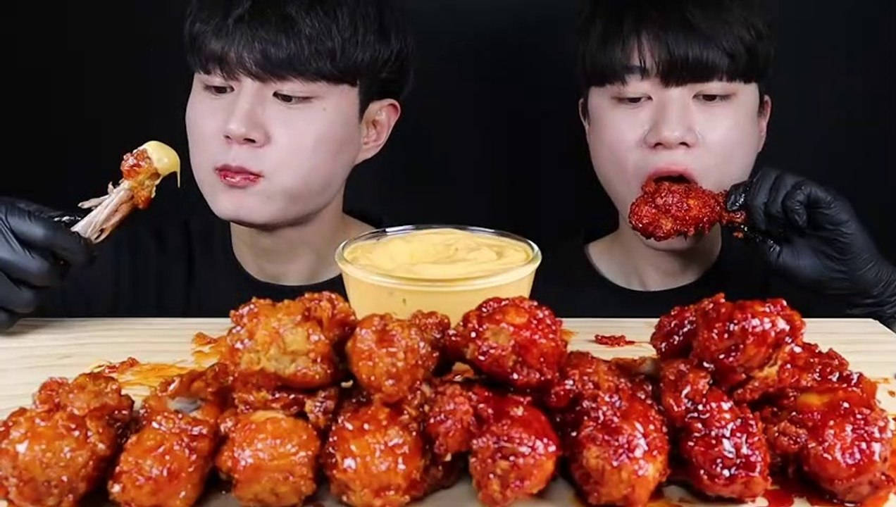 Two Men Are Eating A Plate Of Chicken Wings Wallpaper