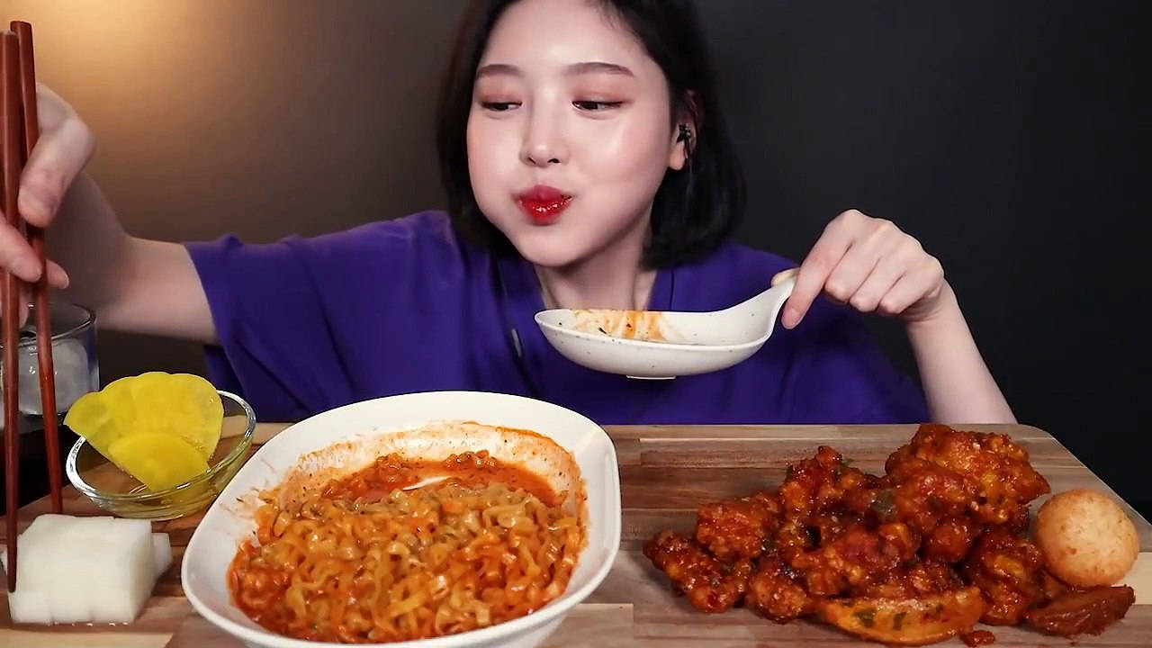 A Woman Eating A Bowl Of Food With Chopsticks Wallpaper