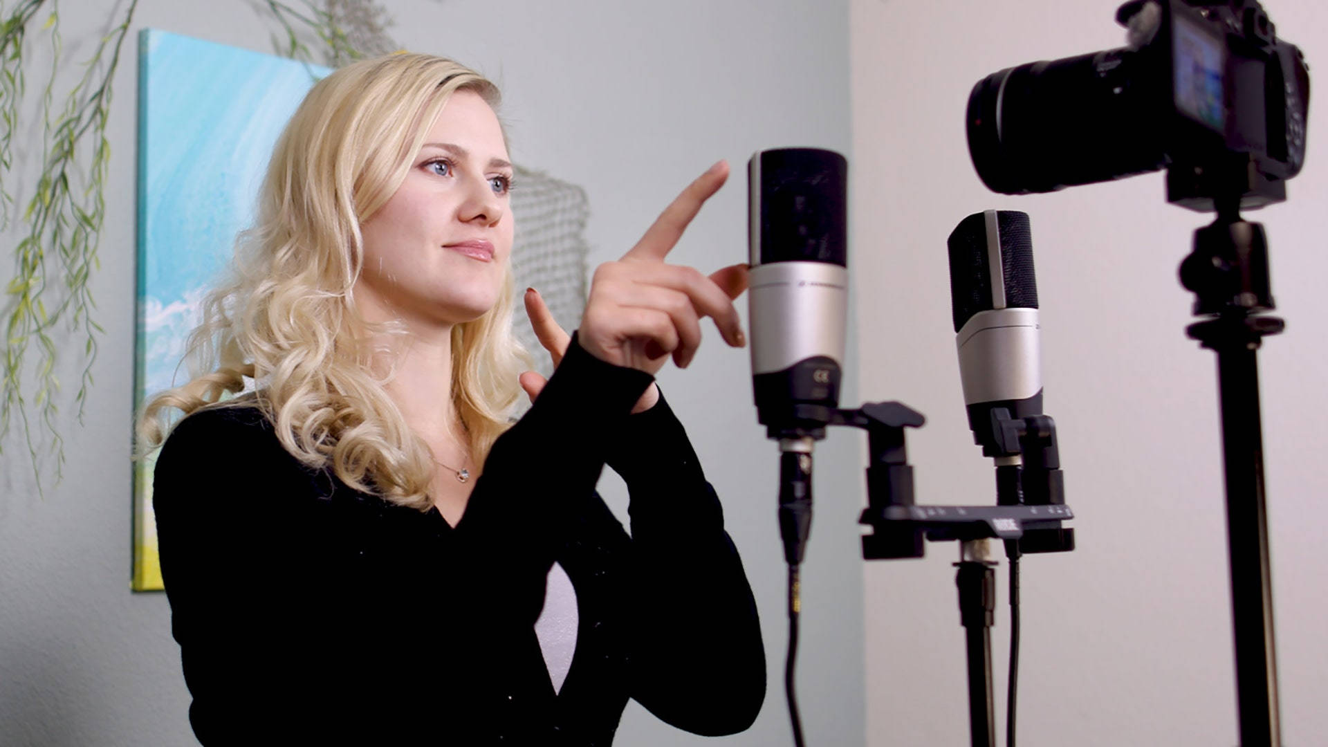 A Woman Is Pointing At A Microphone Wallpaper