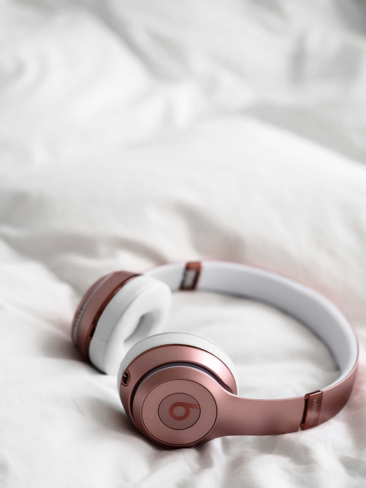 Beats Solo3 Headphones On A Bed Wallpaper