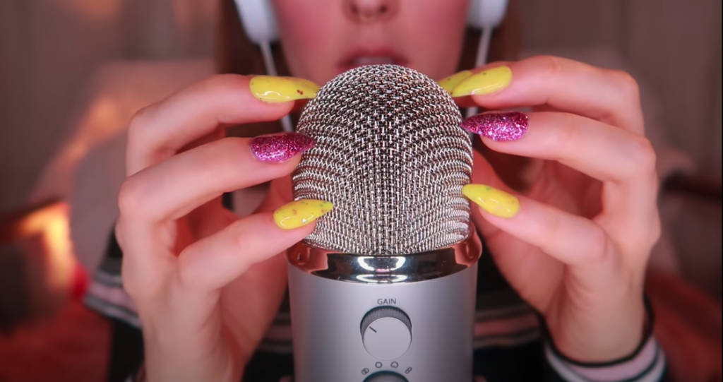 A Girl With A Microphone Holding Her Nails Wallpaper