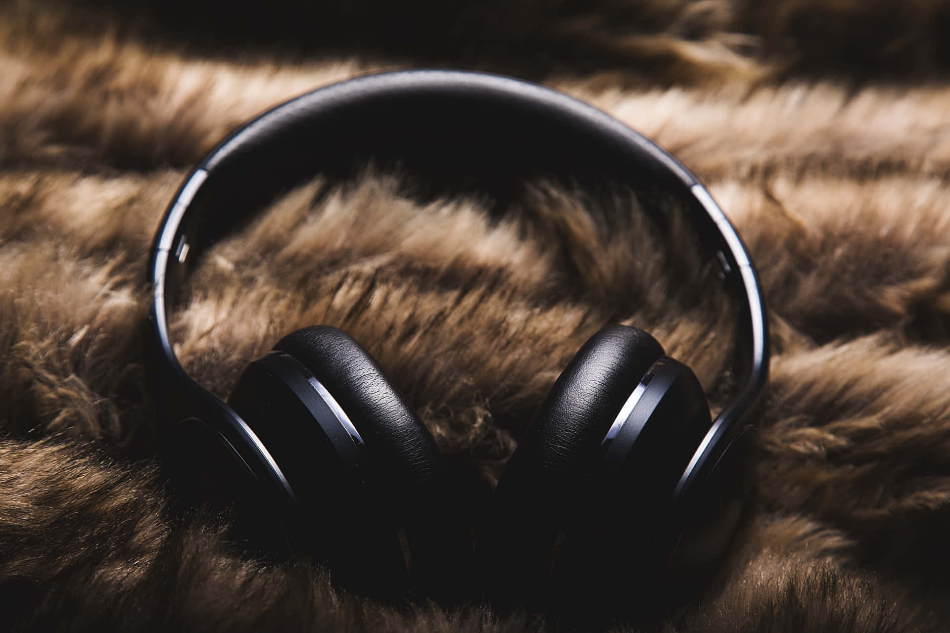 A Pair Of Headphones On A Furry Surface Wallpaper