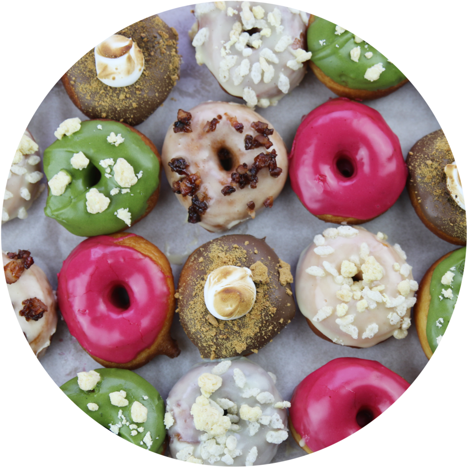 Download Assorted Gourmet Doughnuts Top View | Wallpapers.com