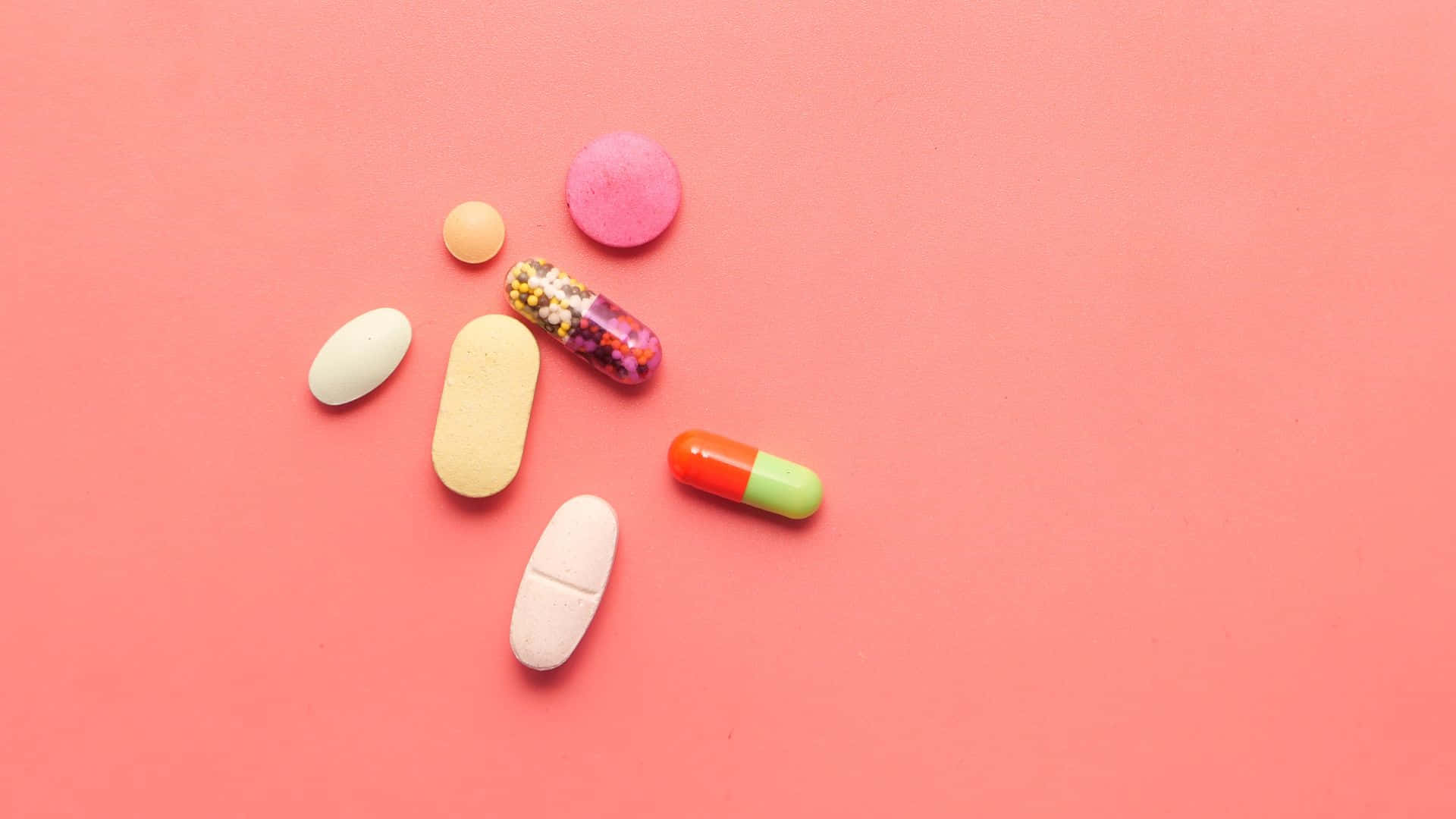 Assorted Medications Pink Background Wallpaper