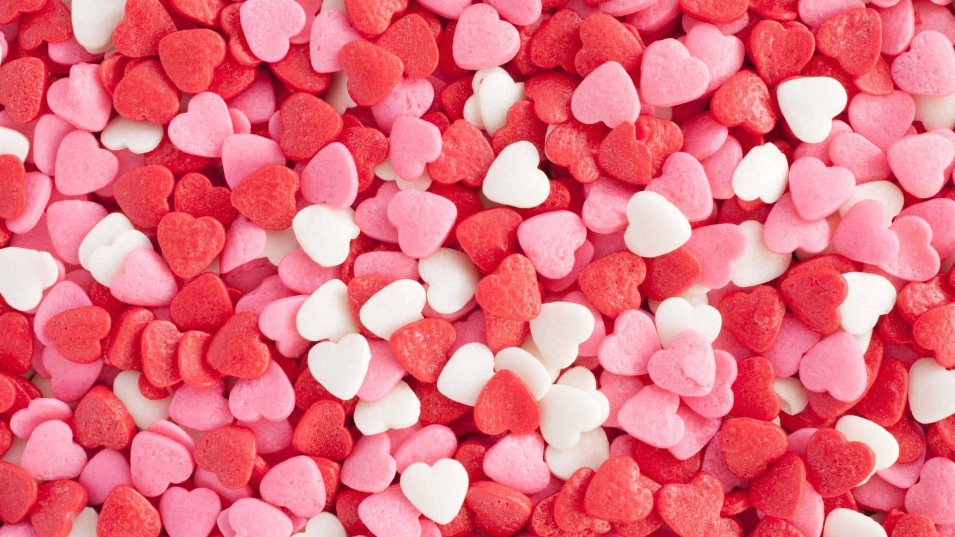 Assorted Pink Heart Candies Background Wallpaper
