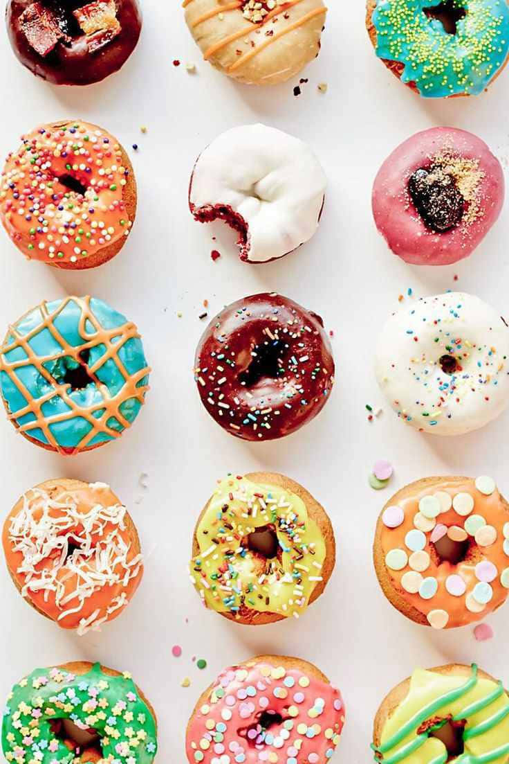 Assortment Of Vibrant, Delicious Donuts On A White Background