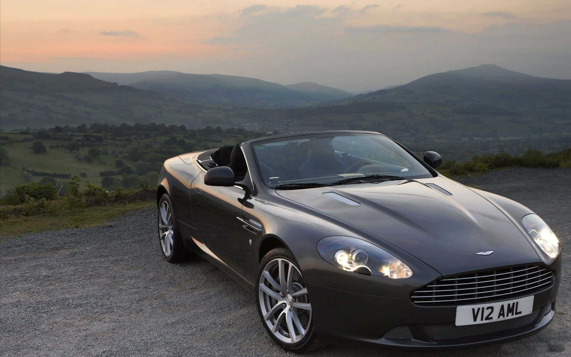 Caption: Sleek Aston Martin DB9 on the Road Wallpaper