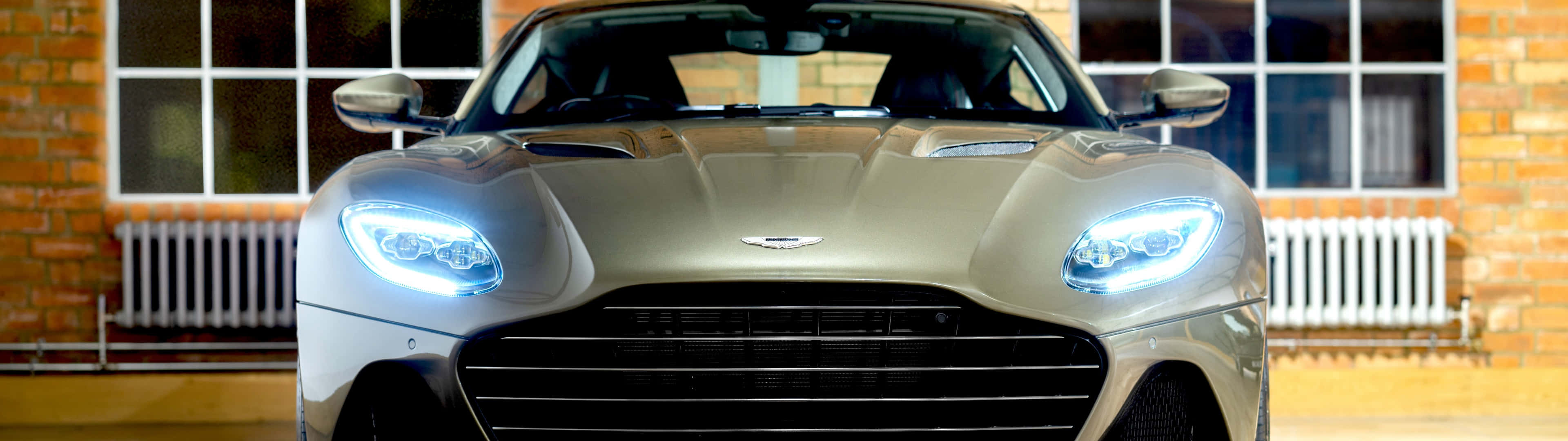 Aston Martin DBS Superleggera on the road, in profile view Wallpaper