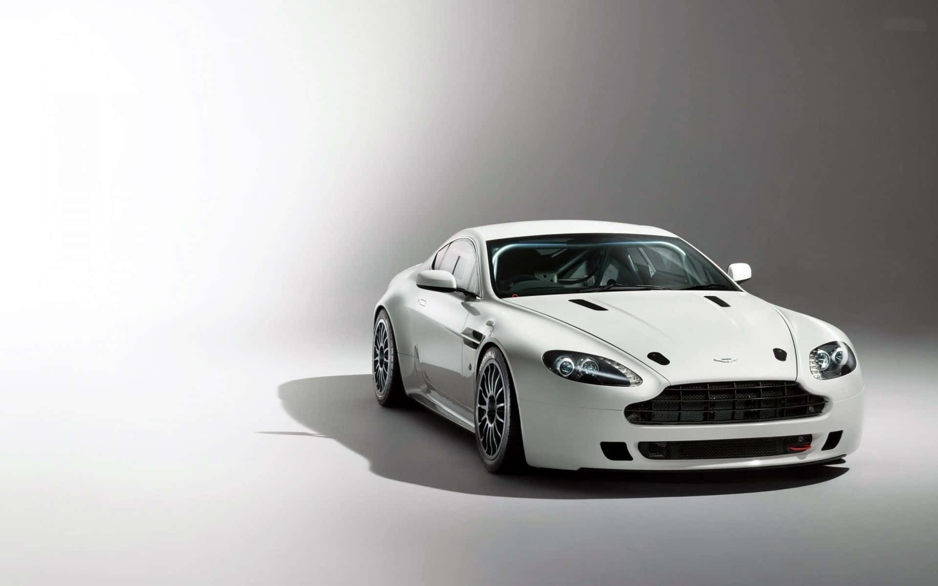 Aston Martin V12 Vantage Unleashing Its Power Wallpaper