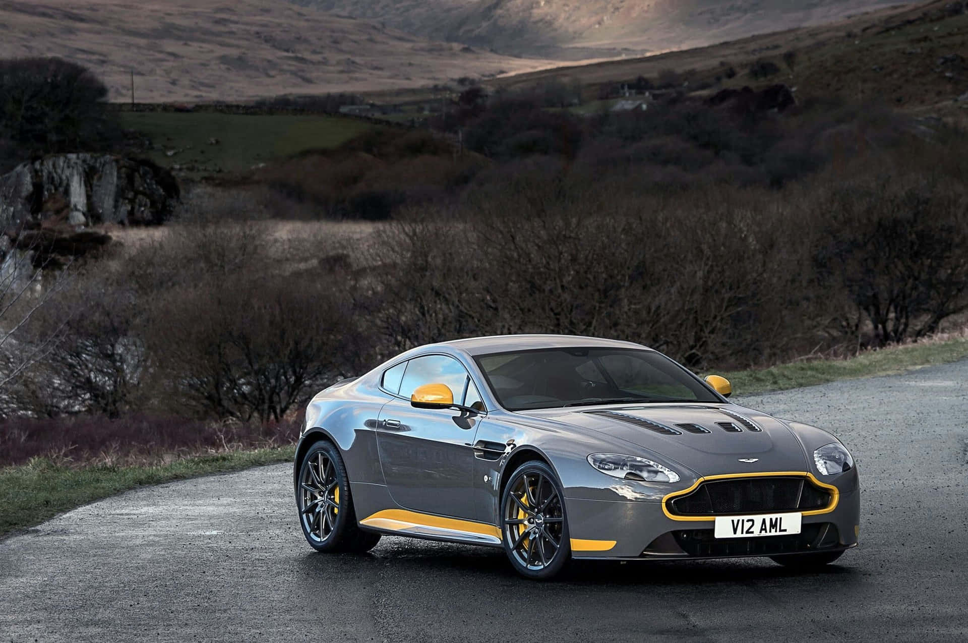 Sleek Aston Martin V12 Vantage on the open road Wallpaper
