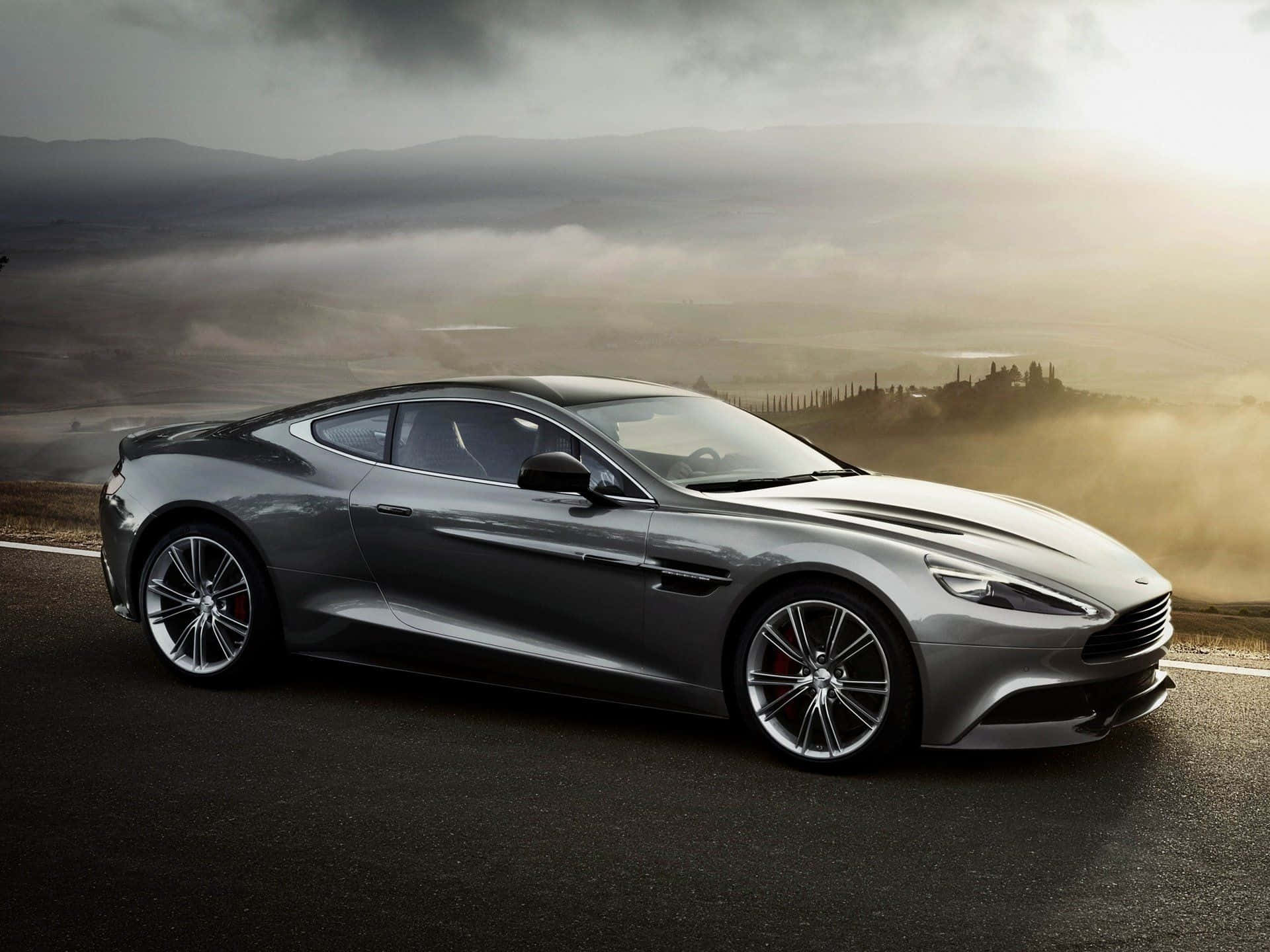 Sleek Aston Martin Vanquish in a Majestic Landscape Wallpaper