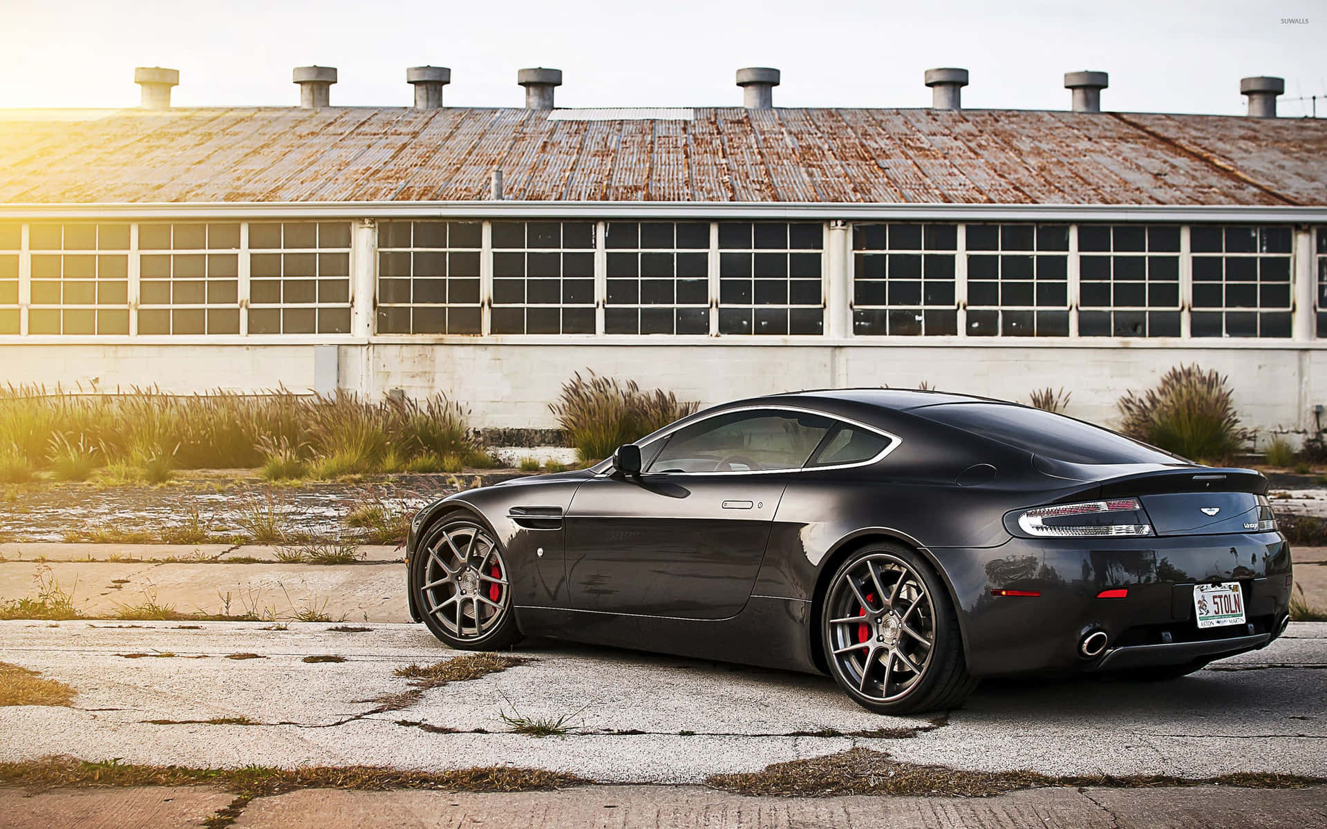 Aston Martin Vanquish in action on a scenic road Wallpaper