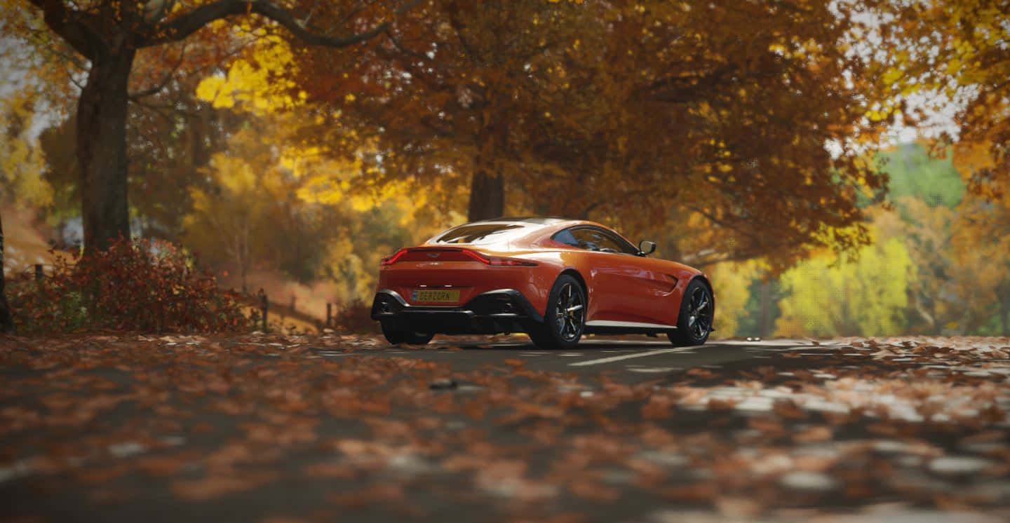 Aston Martin Vantage cruising on an open road Wallpaper