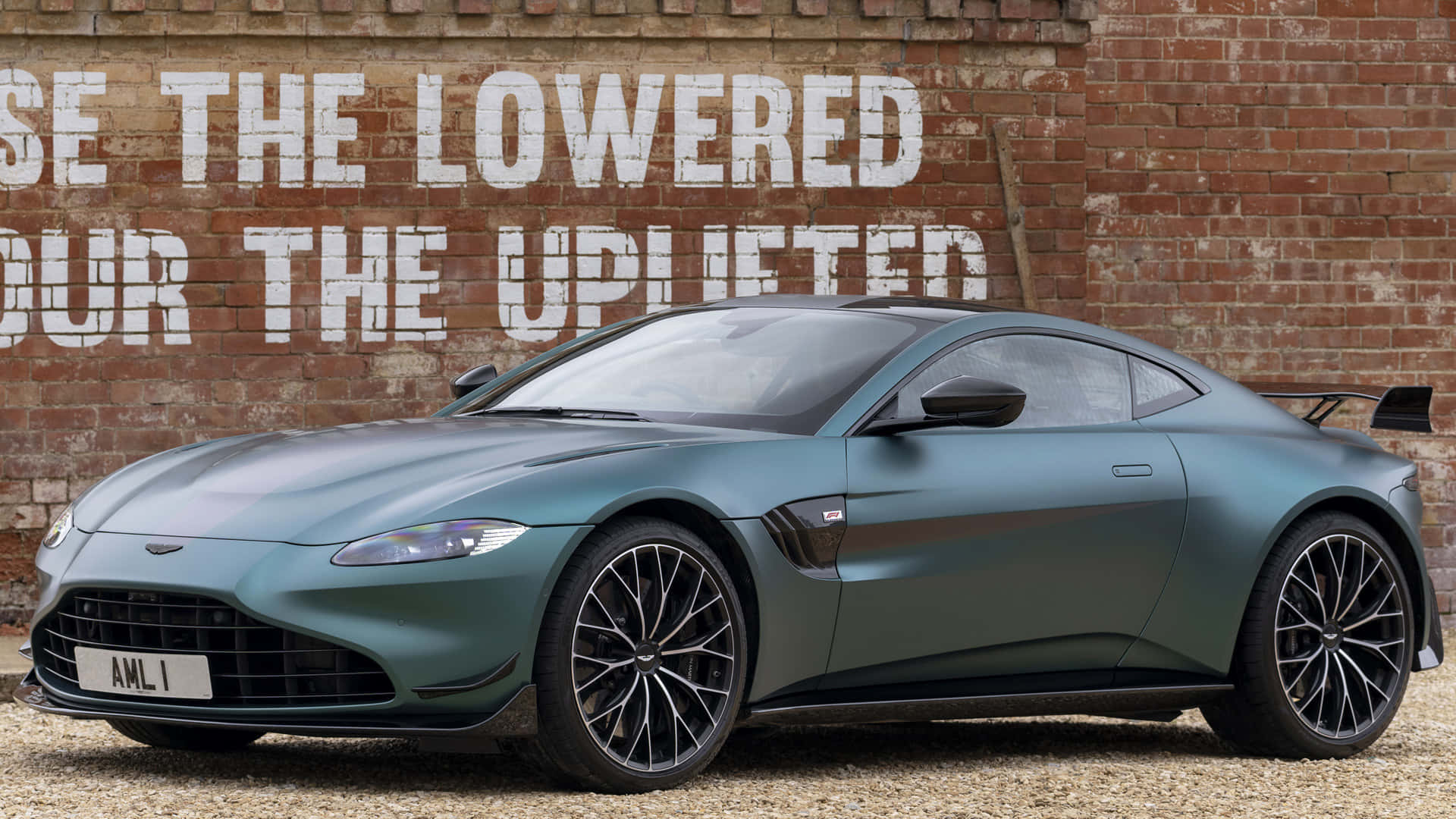 Sleek Aston Martin Vantage Cruising on an Open Road Wallpaper