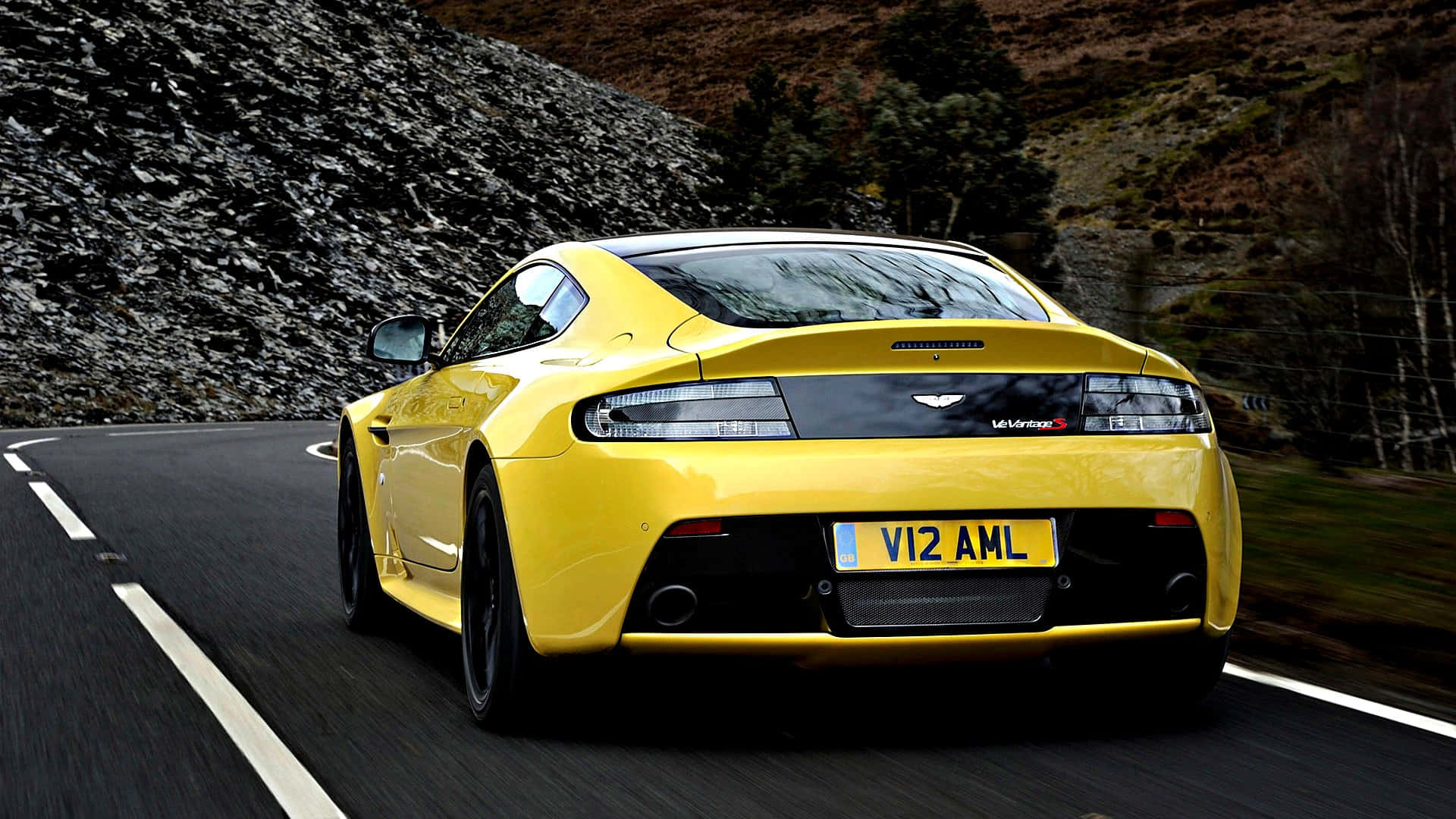 Caption: Aston Martin Vantage - Luxurious Speed and Elegance on the Road Wallpaper