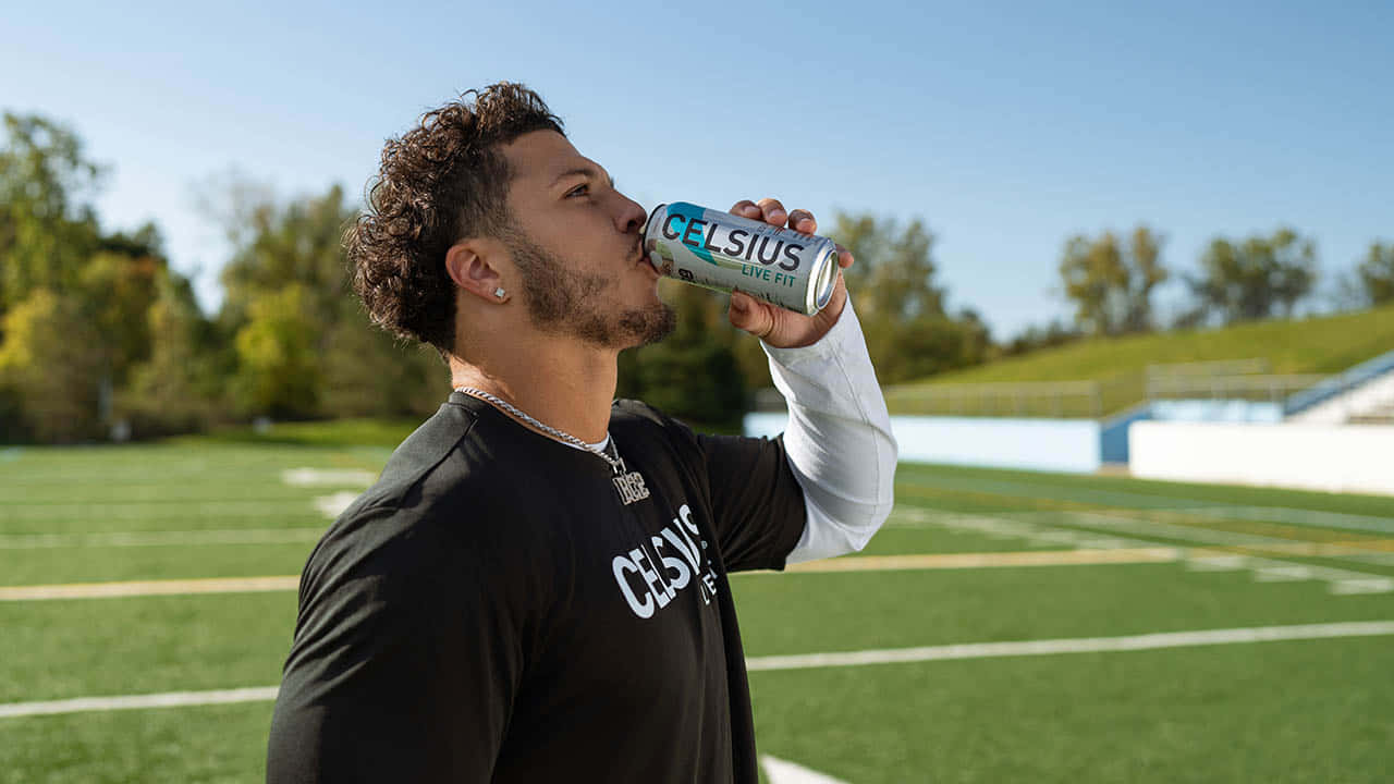 Athlete Drinking Celsius On Field Wallpaper