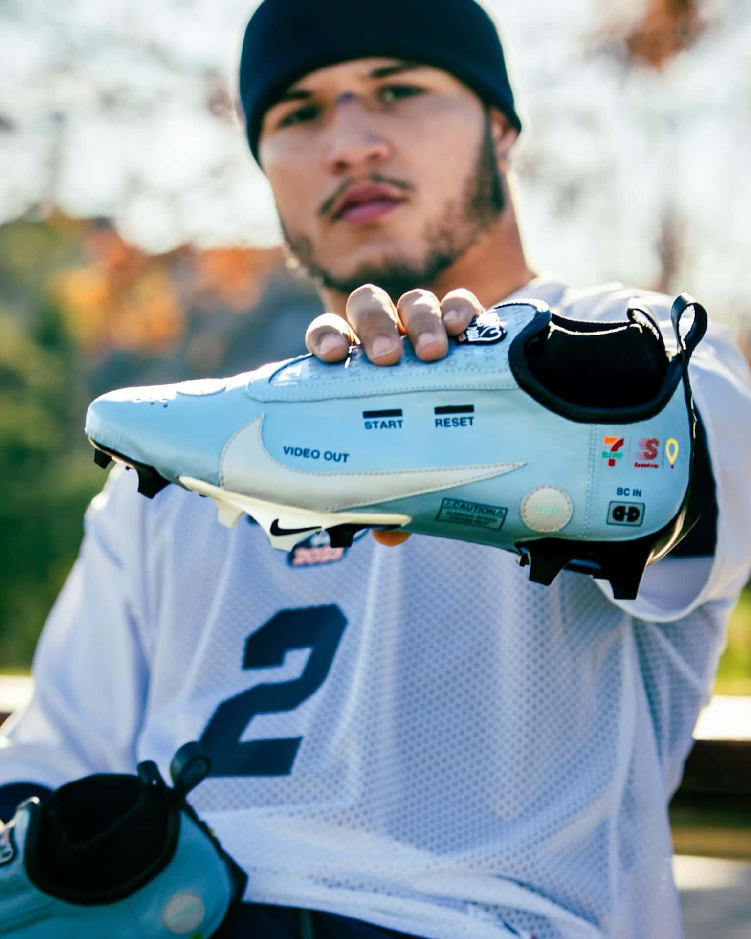 Athlete Holding Custom Cleats Wallpaper